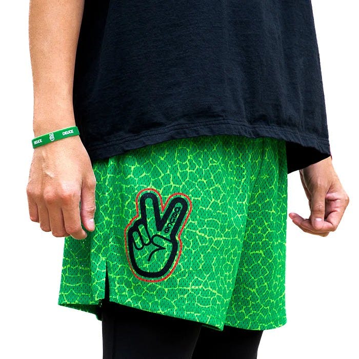 Deuce peace sign logo on bright green scaled shorts pattern