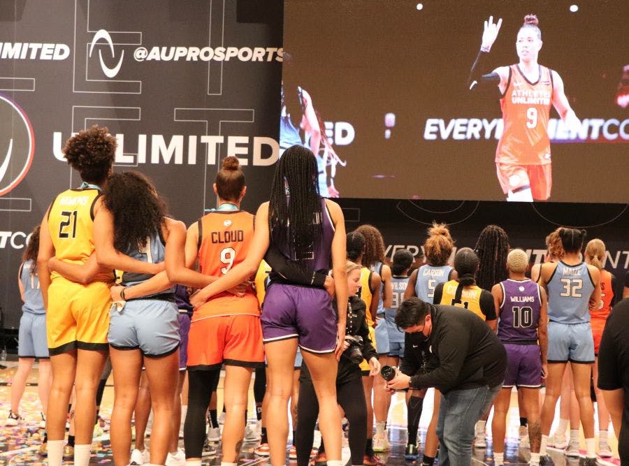 The top four point scorers stand together—Tianna Hawkins, Lexie Brown, Natasha Cloud, and Isabelle Harrison—stand together to watch a montage of the AU season